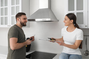 The Best Range Hood Installation: Video Guide in 7 Steps man and woman installing a new kitchen range hood