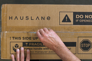 Inspecting your new range hood from hauslane. Hauslane product box.