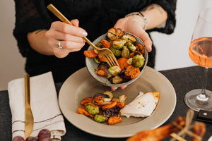 Thanksgiving Side Dishes Woman adding sides to her plate