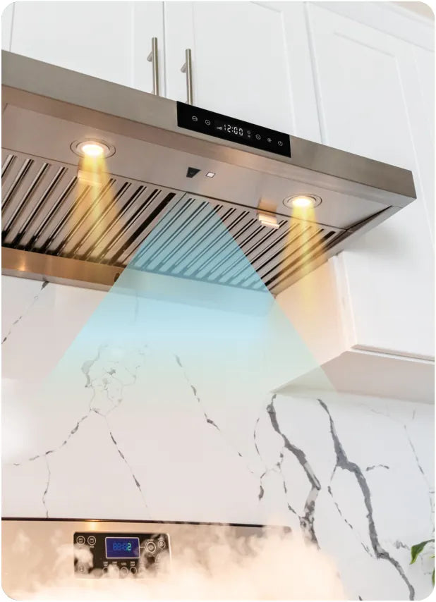 The hood lights turn on as a person approaches the cooktop.